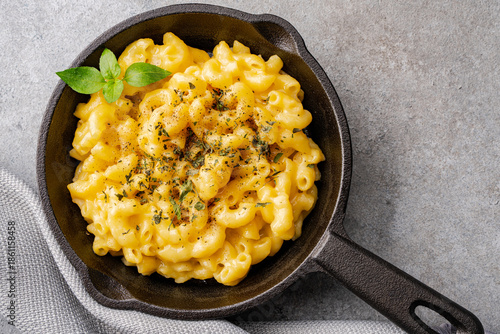 Delicious mac and cheese in a pan on grey stone background