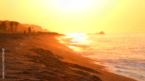 Beautiful sea side view, summer beach in sunrise lights, waves. Beach, coast line, Nature in sunlight. Ocean Sunset, horizon. Landscape, vacation, happiness concept. Slow motion. 