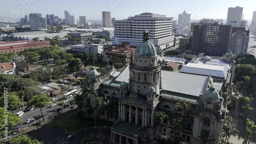 Drone orbits around the front of city hall on a sunny morning in downtown Durban, South Africa