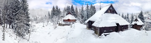 Wallpaper Mural Traditional wooden huts on a snow-covered mountain plateau Velika Planina, Slovenia , panoramic view. Winter scenery high resolution panorama Torontodigital.ca