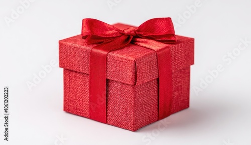 A square red gift box with a matching ribbon and bow, set against a white backdrop