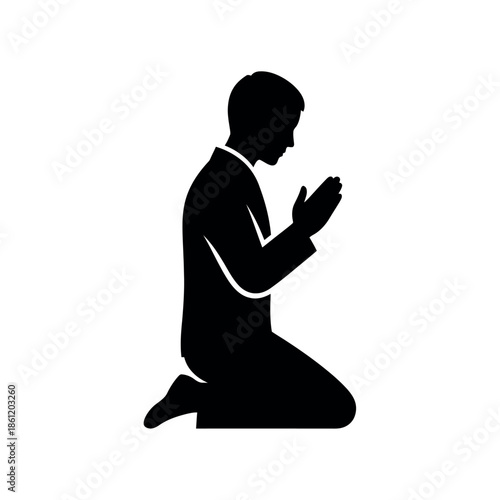 Silhouette of a man kneeling in prayer a symbol of devotion and spirituality.