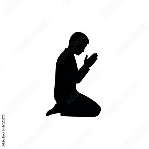Silhouette of a person kneeling and praying.