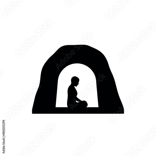 Silhouette of a person meditating in a cave symbolizing introspection and spiritual retreat.