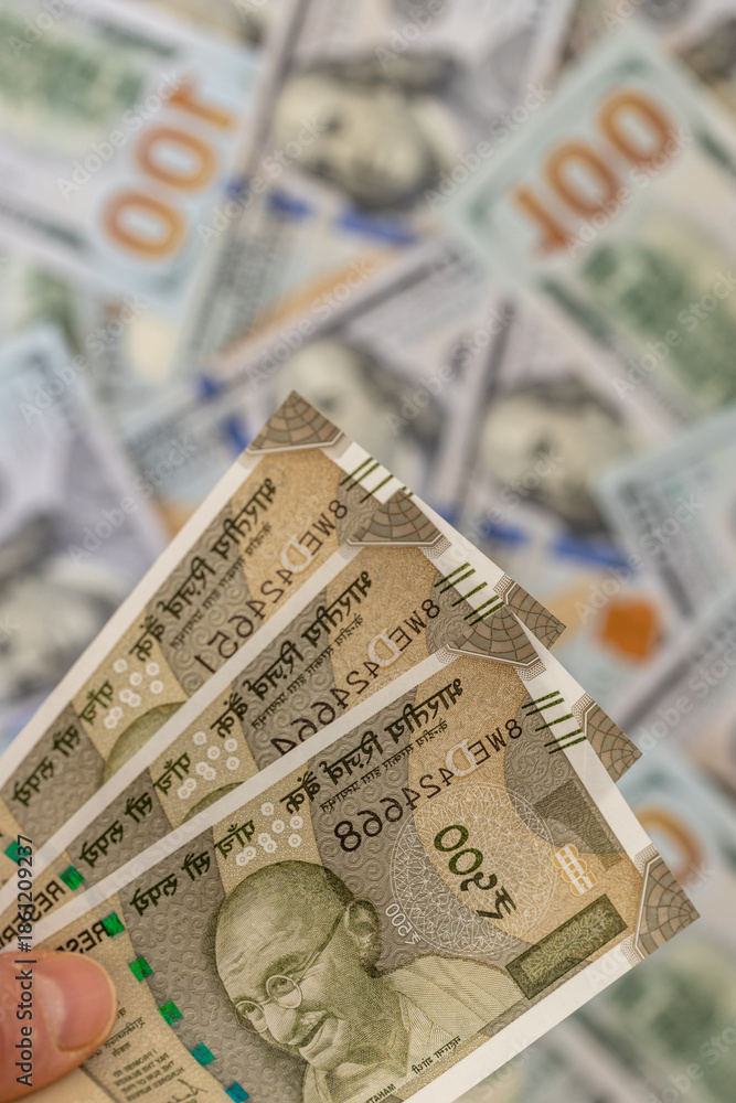 Obraz premium India money. Currency exchange rate. Indian rupees vs US dollar. Economic and financial concept. Banknotes of 500 rupees against USD. business background. Close up. Vertical
