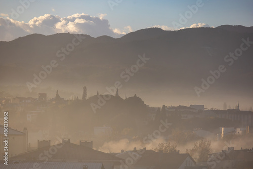 Misty small town landscape in Canakkale Turkey with layered hills and soft morning fog creating a calm atmospheric scene