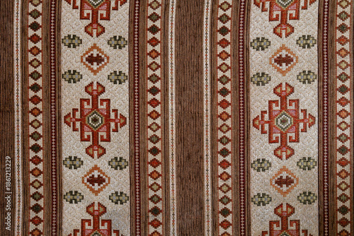 Traditional Anatolian kilim textile pattern with geometric motifs and earthy tones, showcasing handcrafted cultural fabric design
