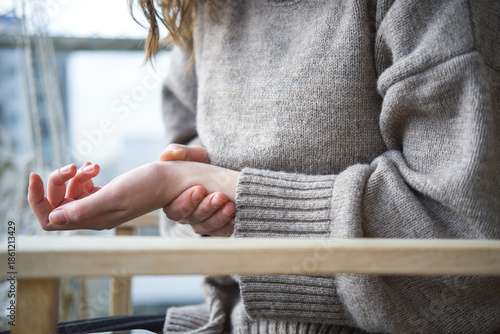 Close-up of woman suffering from hand pain.	