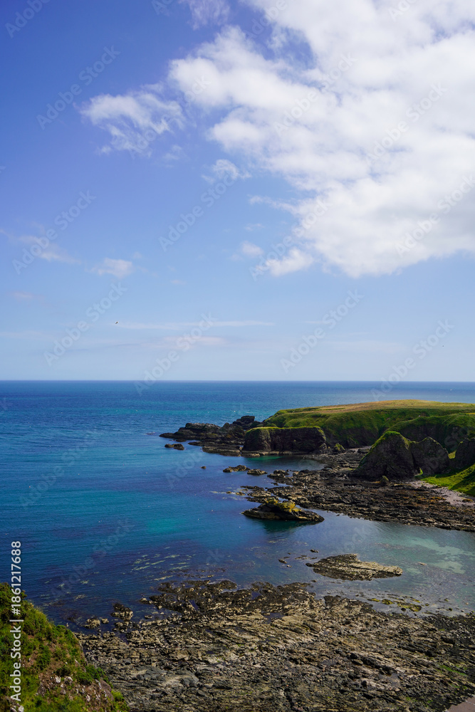 Fototapeta premium Views over fields and coast line rocks in Scotland 