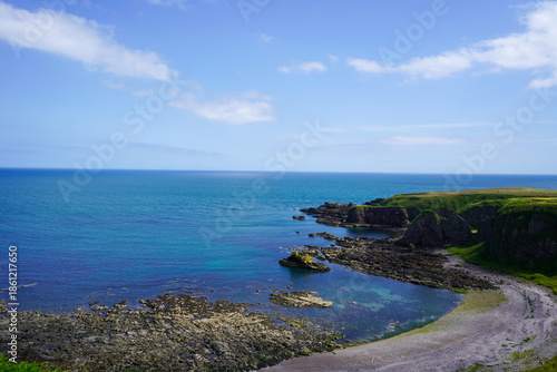 Views over fields and coast line rocks in Scotland 