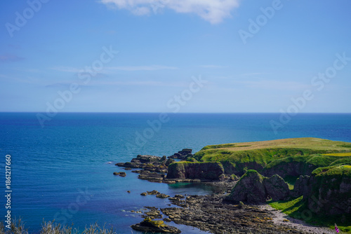 Views over fields and coast line rocks in Scotland 