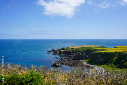 Views over fields and coast line rocks in Scotland 