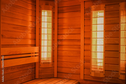 Infrared emitters warming a wooden sauna interior for health and detoxification