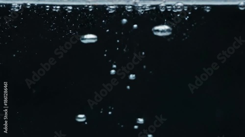 Bubbles ascend in dark liquid