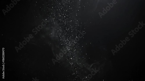 Abstract smoke and glitter movement on a black background