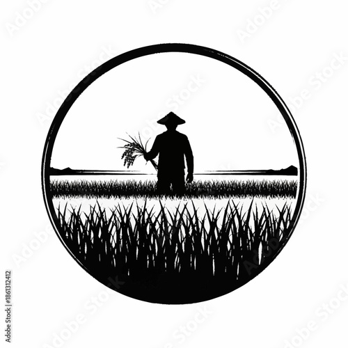 Silhouette of a farmer in a rice field holding a harvest.