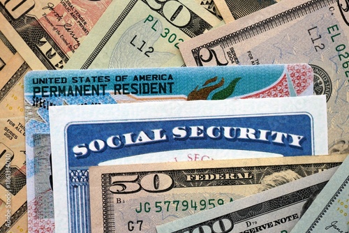 Social security number and permanent resident card with US dollar money bills close up