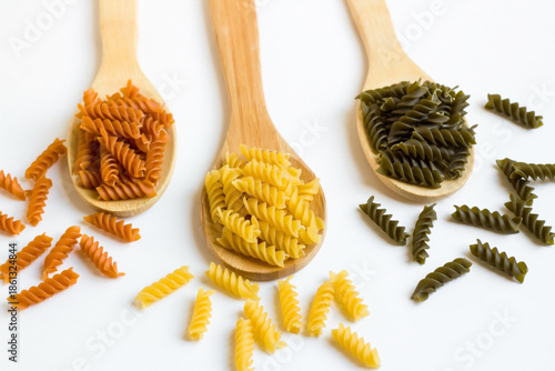 Turkish spiral pasta with tomatoes and spinach was designed in wooden spoons