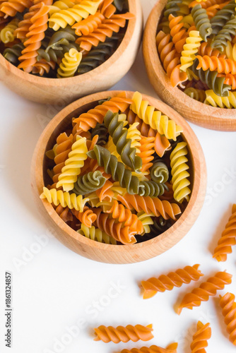 Turkish colorful spiral pasta with tomatoes and spinach was designed in a bamboo bowl