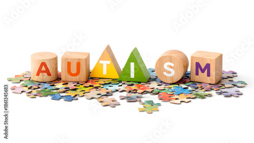 Autism word made of colorful wooden blocks on jigsaw puzzle pieces, symbolizing complexity of neurodiversity and childhood development