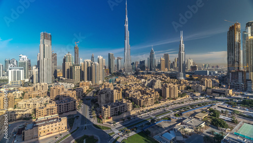 Dubai Downtown skyline timelapse with Burj Khalifa and other towers during sunrise panoramic view from the top in Dubai
