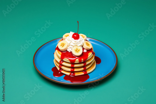 Sweet Stack of Fluffy Pancakes with Whipped Cream Banana Cherry and Berry Syrup on Blue Plate for Delicious Breakfast Brunch Dessert Menus and Ads