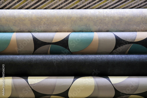 Wallpaper with geometric patterns. Rolls of vinyl wallpaper. Various textures and colors of paper for wall.