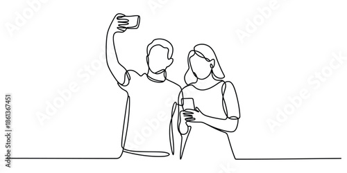 Young couple capturing a moment with a selfie while also engaged with individual phones
