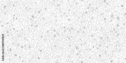 Close up of a white textured surface with scattered dark speckles