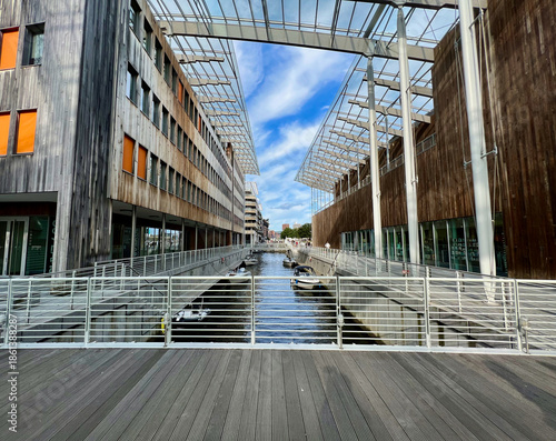 Canvas Print View of the Astrup Fearnley Museum in Oslo, Norway, featuring modern waterfront architecture, canal, moored boats, and contemporary urban design