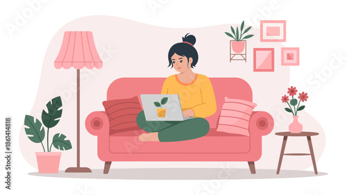 A woman working remotely or studying on a laptop from the comfort of her home sofa