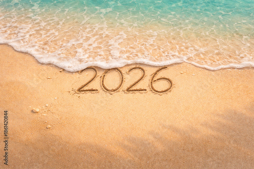 2026 Written in Sand on Beach with Gentle Sea Wave – Aerial New Year Concept