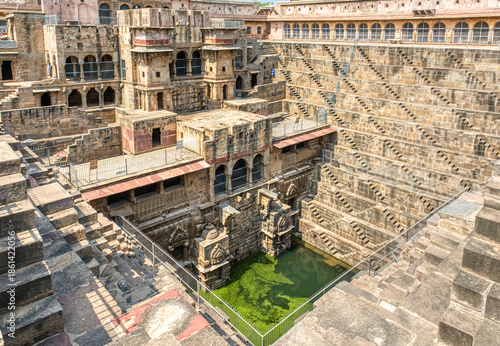 Chand Baori in Abhaneri, built in the 8th–9th century CE by King Chanda, is a deep, geometric stepwell with 3,500 steps, showcasing ancient water conservation, climate-smart design.