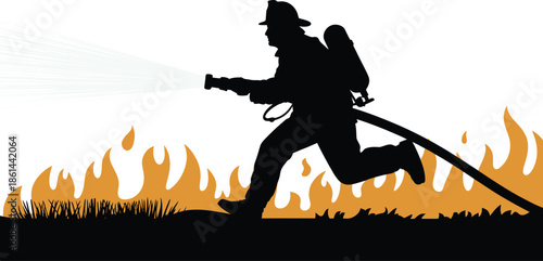 Firefighter silhouette runs forward while spraying water from a hose onto a ground level grass fire blaze.
