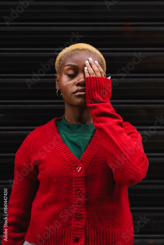 Young black woman covering eye conveying themes of vision, protection, and urban style