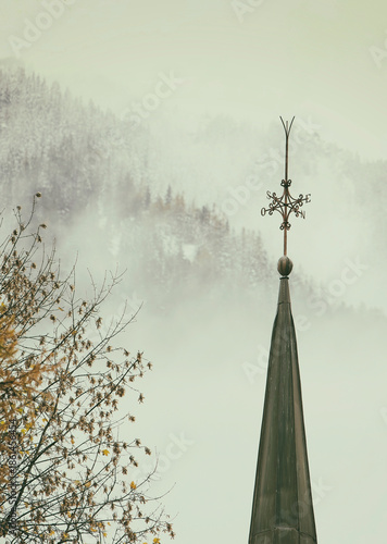 Bell tower of the church of Saint Michael in Chamonix shrouded in fog, Switzerland II