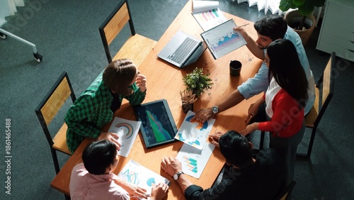 Top view of project manager present financial graph to investors at meeting. Professional marketing team brainstorming financial idea while looking at financial statistic from laptop. Convocation.