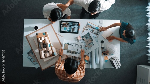 Top view of skilled architect engineer working together and shaking hand cooperative team while making contract and dealing. Aerial view of project manager talking and explain design. Alimentation.