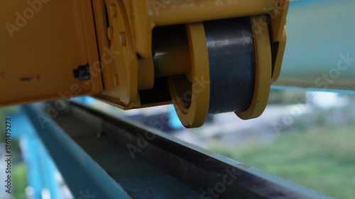 Mounting an overhead crane onto rails. The process of mounting an industrial overhead crane, lifting it, and installing it onto steel rails inside a production facility.