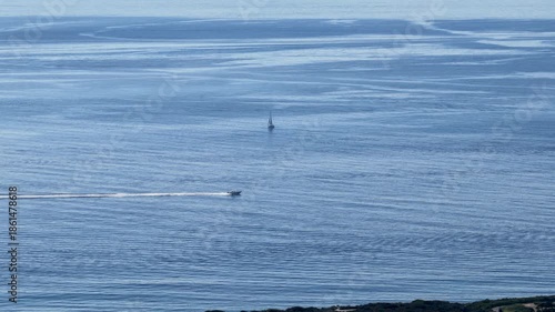 Aerial footage of a motorboat sailing across the ocean in Newport Beach California USA