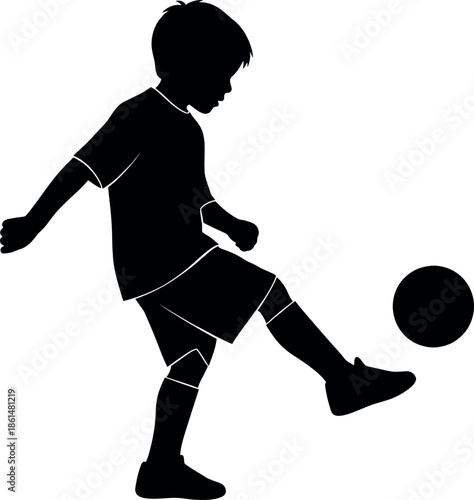 Silhouette of a young boy kicking a soccer ball with motion and energy