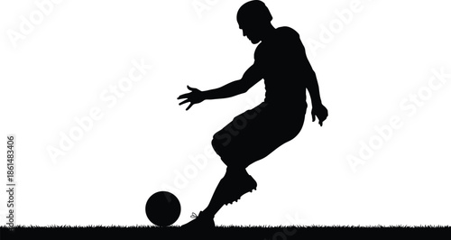 Soccer player silhouette kicking ball on grass