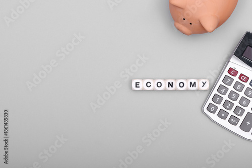 Economy represented with piggy bank and calculator.
