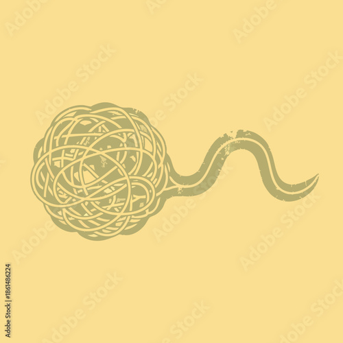 Tangled yarn ball with winding tail closeup.