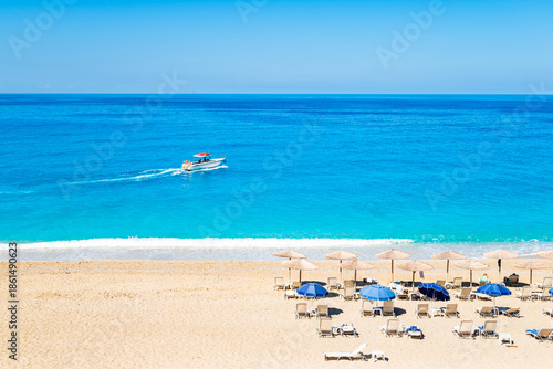 Wallpaper Mural Motor boat on blue sea sailing off Milos beach, Lefkada island, Greece Torontodigital.ca