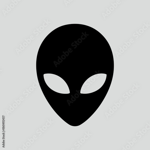 Simple black alien head illustration with white eyes on gray background representing extraterrestrial life or science fiction theme