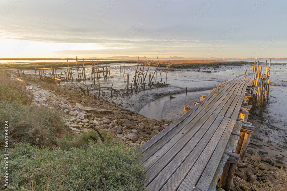Fototapeta premium Carrasqueira palafitic port wooden pier sunset in portugal