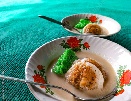 A bowl of kue serabi Ngampin, Ambarawa. Serabi with coconut milk sauce. A traditional Indonesian dessert. Close-up.
