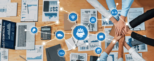 Billede på lærred A dynamic business environment showcasing teamwork around a desk with financial charts and digital devices
