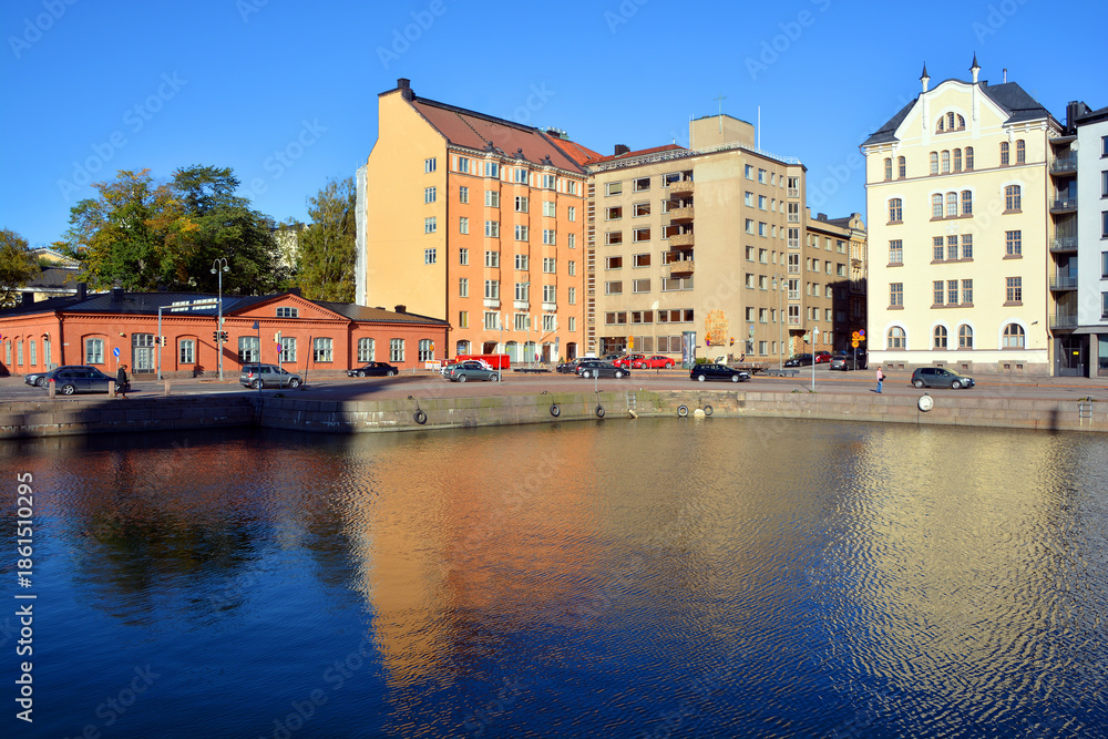 Fototapeta premium Pohjoisranta is located in center and runs along northern harbor Helsinki Finland. On waterfront there are houses built in different architectural styles in different historical periods